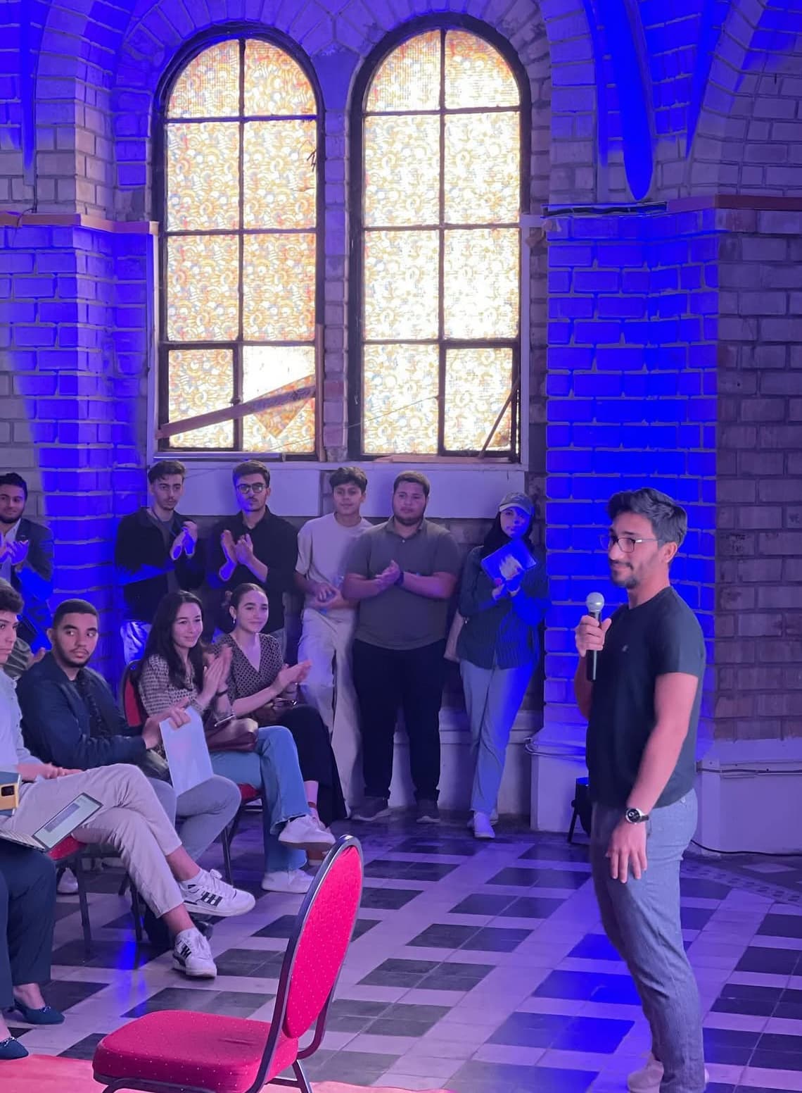 Meziane Dahou speaking on stage